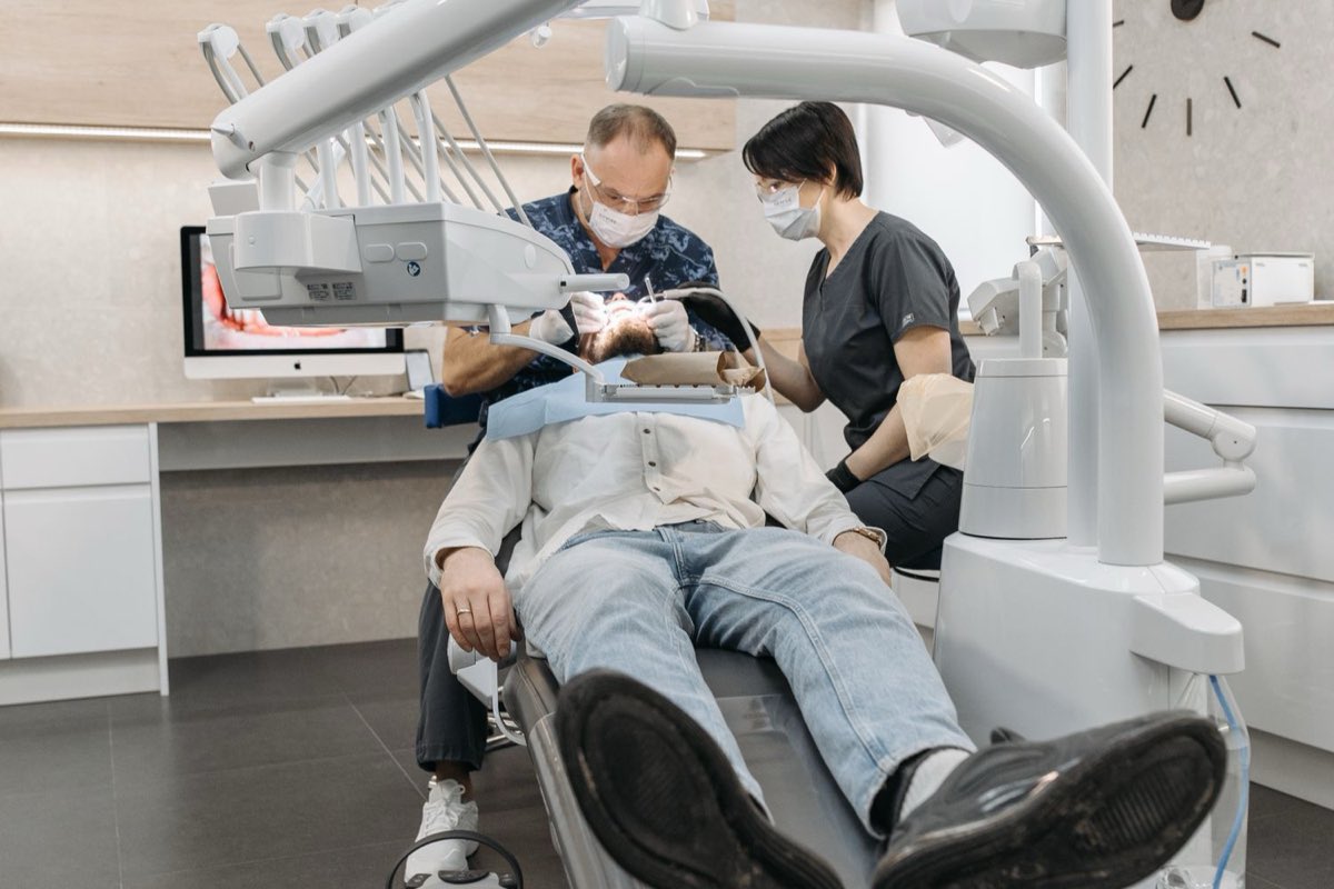 A dentist and assistant treating a patient